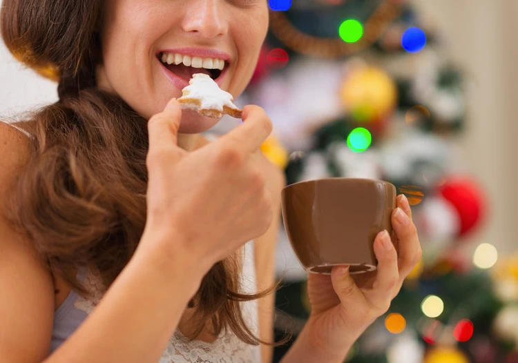 Woman eating Christmas cookie